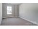 Spacious bedroom with large window and neutral carpeting at 4113 Black Ct # 167, Harrisburg, NC 28075