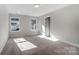 Bright bedroom with neutral walls and two windows at 4113 Black Ct # 167, Harrisburg, NC 28075