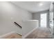 Upstairs hallway with carpet and access to bedrooms at 4113 Black Ct # 167, Harrisburg, NC 28075