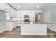 Modern kitchen with white cabinets, granite countertops, and an island at 4113 Black Ct # 167, Harrisburg, NC 28075
