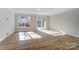 Spacious living room with hardwood floors and access to a patio at 4113 Black Ct # 167, Harrisburg, NC 28075