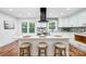 Modern kitchen with white cabinets, marble island, stainless steel appliances, and mosaic backsplash at 6405 Mill Grove Rd, Indian Trail, NC 28079