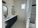 Bathroom features double vanity with black hardware and neutral color tile flooring at 7392 Deer Hollow Rd # 27, Sherrills Ford, NC 28673