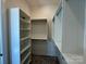 An organized walk-in closet featuring white shelving and clothing rods for storage at 7392 Deer Hollow Rd # 27, Sherrills Ford, NC 28673