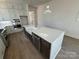 Kitchen featuring stainless steel appliances, white countertops, a center island with seating, and hardwood floors at 7392 Deer Hollow Rd # 27, Sherrills Ford, NC 28673