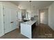 Open concept kitchen features a center island with white countertops, stylish fixtures and hardwood floors at 7392 Deer Hollow Rd # 27, Sherrills Ford, NC 28673