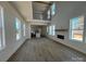 Open-concept living space with hardwood floors, large windows, fireplace and kitchen access at 7392 Deer Hollow Rd # 27, Sherrills Ford, NC 28673
