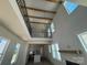 Bright, open living room with tall ceilings, exposed beams, modern fireplace and views to the kitchen at 7392 Deer Hollow Rd # 27, Sherrills Ford, NC 28673