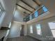 Living room featuring vaulted ceilings with wooden beams, fireplace, many windows, and wood floors at 7392 Deer Hollow Rd # 27, Sherrills Ford, NC 28673