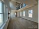 Bright, open living room with wood floors, high ceilings, fireplace, and many windows at 7392 Deer Hollow Rd # 27, Sherrills Ford, NC 28673