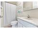 Bright bathroom featuring a shower with curtain, shelves and a vanity with a toilet at 7831 Spinnaker Bay Dr # 314, Sherrills Ford, NC 28673