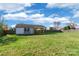 Spacious backyard featuring a storage shed with garage door and covered area at 1114 Fenwick Ct, Clover, SC 29710