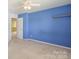 Blue bedroom with carpet and neutral walls and doorway to another room at 1114 Fenwick Ct, Clover, SC 29710