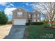 Charming two-story home featuring a well-manicured front yard and a two-car garage, perfect for a growing Gathering at 1114 Fenwick Ct, Clover, SC 29710