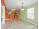 Bright kitchen and dining area featuring tile floors and appliances with plenty of cabinet and counter space at 1114 Fenwick Ct, Clover, SC 29710
