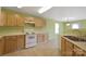 Kitchen featuring light wood cabinets, tile floor, and white appliances at 1114 Fenwick Ct, Clover, SC 29710