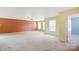 Large living area featuring neutral carpet, fresh paint, and natural light at 1114 Fenwick Ct, Clover, SC 29710