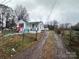 Front yard view of charming house with a long driveway at 1210 Butler St, Salisbury, NC 28144