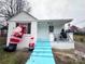 Cute cottage with light blue steps and inflatable Santas at 1210 Butler St, Salisbury, NC 28144