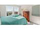 Bright bedroom with double windows, dresser, and teal bedding at 16042 River Tree Ln, Charlotte, NC 28278