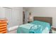 Bedroom with double doors to closet and teal bedding at 16042 River Tree Ln, Charlotte, NC 28278