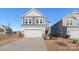 Two-story house with gray siding, white trim, and a two-car garage at 16042 River Tree Ln, Charlotte, NC 28278