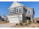 Two-story house with gray siding, white trim, and a two-car garage at 16042 River Tree Ln, Charlotte, NC 28278