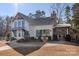 White farmhouse exterior with covered porch at 16042 River Tree Ln, Charlotte, NC 28278