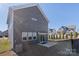 Gray house exterior with sliding glass doors at 16042 River Tree Ln, Charlotte, NC 28278