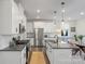 Modern kitchen with white cabinetry, stainless steel appliances, and a large island at 16042 River Tree Ln, Charlotte, NC 28278