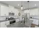 Modern kitchen with white cabinets, stainless steel appliances, and quartz countertops at 16042 River Tree Ln, Charlotte, NC 28278