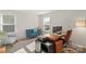 Home office with desk, two monitors, and comfy chairs at 16042 River Tree Ln, Charlotte, NC 28278