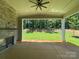Relaxing covered patio with stone fireplace and ceiling fan overlooking the private backyard at 2007 Kendall Dr # 6, Wesley Chapel, NC 28173