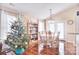Cozy dining room with hardwood floors, natural light, and adjacent bookcase at 3076 Champion Sw Ln, Concord, NC 28025