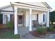 Inviting front porch with seating area perfect for relaxing and enjoying the outdoors at 3076 Champion Sw Ln, Concord, NC 28025