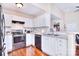 Well-appointed kitchen featuring white cabinets, updated appliances and a breakfast bar at 3076 Champion Sw Ln, Concord, NC 28025