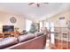 Inviting living room with hardwood floors, comfortable seating, and view of the dining area and kitchen at 3076 Champion Sw Ln, Concord, NC 28025