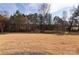 Expansive backyard with lush grass and mature trees in the background, providing privacy and a natural setting at 3611 Whitney Way, Terrell, NC 28682