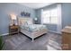 Cozy bedroom with soft blue walls, carpeted floors, and a bright window at 3611 Whitney Way, Terrell, NC 28682