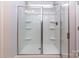 Modern shower with a glass door and built-in shelving for convenience and organization at 3611 Whitney Way, Terrell, NC 28682