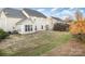 This back yard features a well-maintained lawn with landscaping and a stone patio at 11005 Magna Ln, Indian Trail, NC 28079
