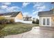 This spacious back yard features a well-maintained lawn, landscaping, a stone patio, and a white fence at 11005 Magna Ln, Indian Trail, NC 28079