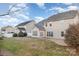 This large back yard features a well-maintained lawn with landscaping, a stone patio, and a white fence at 11005 Magna Ln, Indian Trail, NC 28079