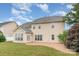 Exterior of home, showing a well-maintained lawn, patio, and manicured landscaping at 11005 Magna Ln, Indian Trail, NC 28079