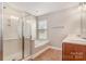 Bright bathroom featuring a glass shower, soaking tub, and double sink vanity with tile flooring at 11005 Magna Ln, Indian Trail, NC 28079