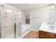 Bathroom featuring a glass-enclosed shower, soaking tub, double sink vanity, and tile flooring at 11005 Magna Ln, Indian Trail, NC 28079