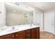 Bathroom featuring a double sink vanity, large mirror, a shower with curtain, and wood-look vinyl flooring at 11005 Magna Ln, Indian Trail, NC 28079