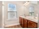 Bathroom featuring a double sink vanity, a bright window, and wood-look flooring at 11005 Magna Ln, Indian Trail, NC 28079
