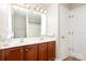 Bathroom featuring a double sink vanity, large mirror, a shower with curtain, and wood-look vinyl flooring at 11005 Magna Ln, Indian Trail, NC 28079