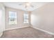 Bright bedroom with two windows, a ceiling fan, and plush carpeting for comfort at 11005 Magna Ln, Indian Trail, NC 28079